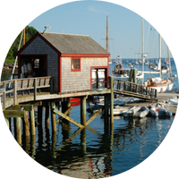 Photo of pier house and bay with sailboats